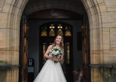 Bride going into church smiling