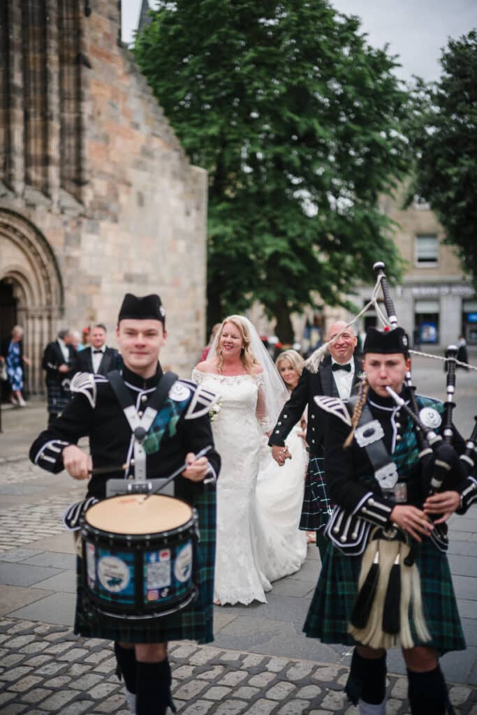 Bride and Groom are piped through St Andrews town with a drummer