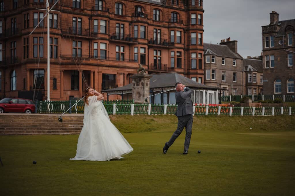 Bride and groom swing golf clubs on the first tee of the Old Course in St Andrews
