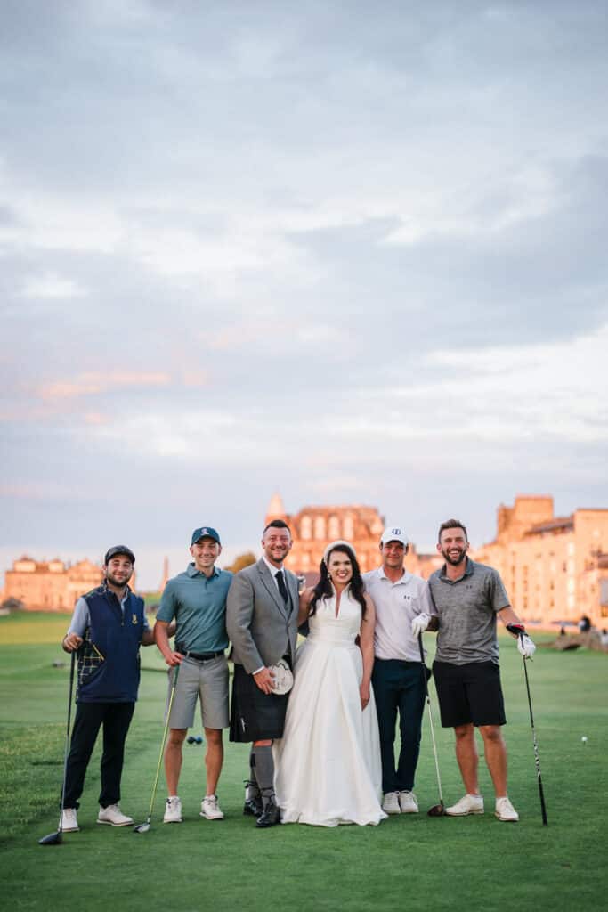 Bride and groom pose with golfers on the Old Course at St Andrews