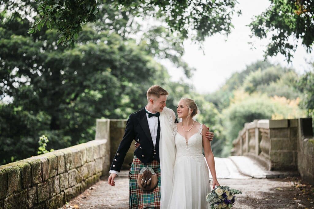 Bride and Groom walk together through Pollok Park in Glasgow